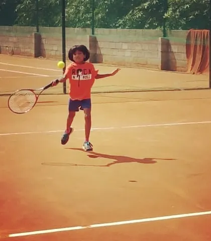 A very young player shows great enthusiasm and form hitting a forehand during the UTR Tour.