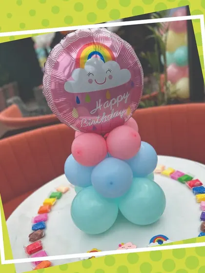 Details from a Monsoon-themed birthday, featuring a cute rainbow balloon centerpiece and colorful clay packs ready for the kids. We take care of all the little details, including decor and art supplies.