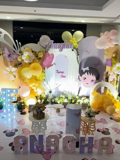 A clear, centered shot of the garden party stage, showing the "ONE" marquee letters and personalized name.