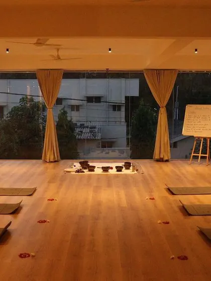 A view of our yoga studio in the evening. The warm lighting and open space create a tranquil environment, perfect for unwinding and focusing on your practice after a long day.