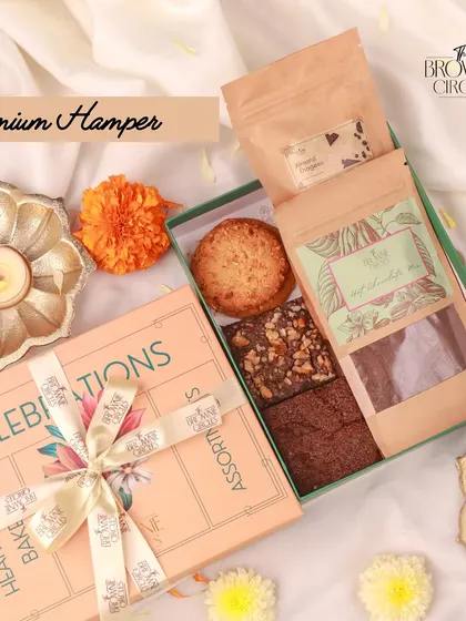 The Premium Hamper is a compact yet delightful gift. It contains our classic and walnut brownies, a crunchy cookie, and our popular hot chocolate mix, making for a heartwarming gesture.