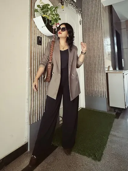 A perfect example of modern power dressing. This look combines a structured blazer with elegant wide-legged pants, creating a silhouette that is both authoritative and chic for the corporate environment.