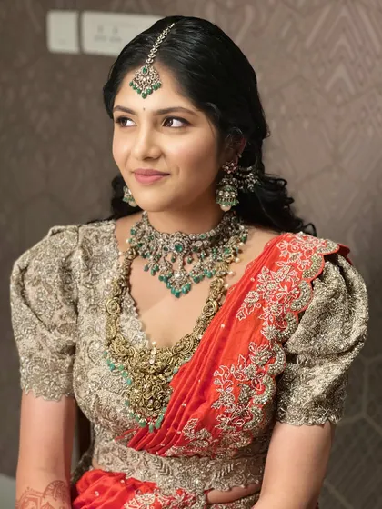A beautiful portrait in a half-saree. The makeup is fresh and radiant, with a focus on enhancing youthful features while maintaining a sense of tradition.