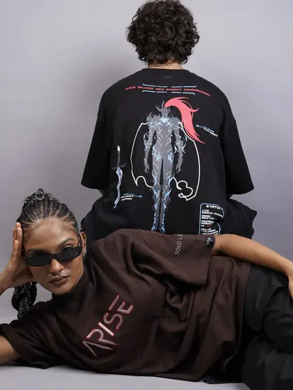 This artistic, reclining pose offers a unique perspective for a lookbook. It effectively displays the graphics on both t-shirts while creating a visually dynamic and modern composition.