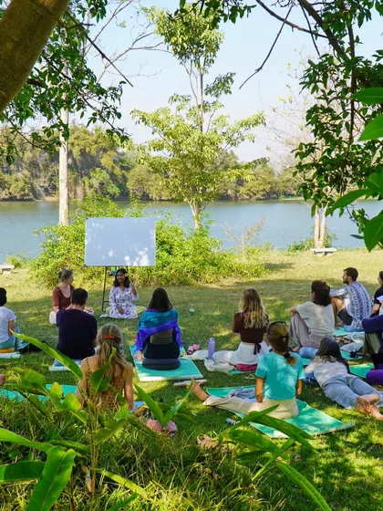 A teaching practice session by the river. Our 200-hour YTT graduates gain the confidence and skills to lead their own classes.