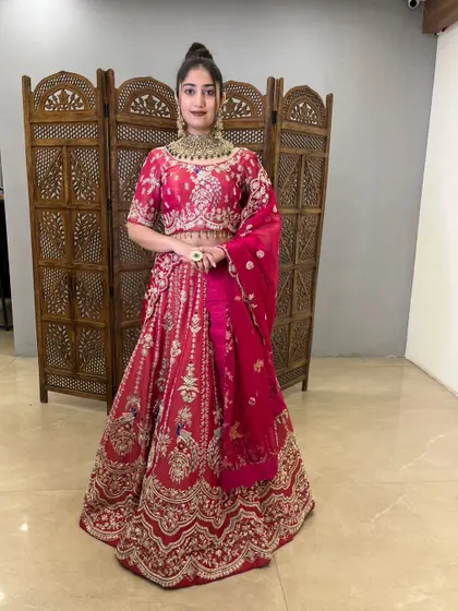 A classic pose in this beautiful pink lehenga, ready for a wedding celebration.