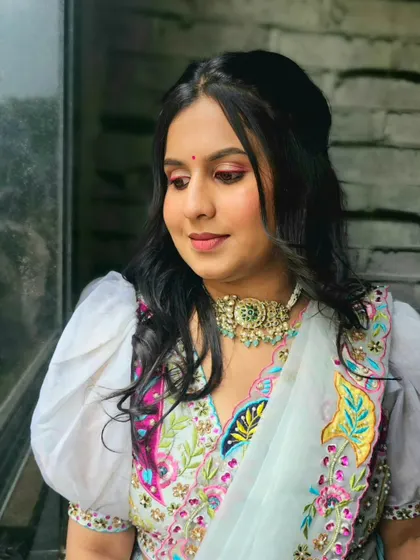 The final look, featuring a pop of pink on the eyes and a lovely embroidered outfit.
