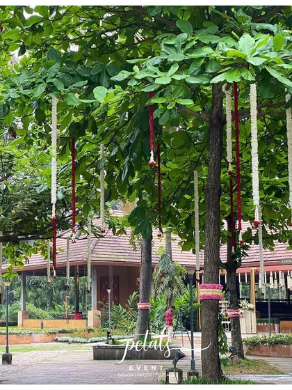 Floral streamers hang from the trees, creating a beautiful and natural decoration.