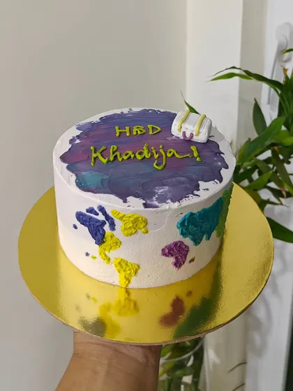 A fun, travel-themed cake for a birthday celebration. I used a watercolor buttercream effect to create a world map on the side of the cake, complete with a tiny suitcase on top.