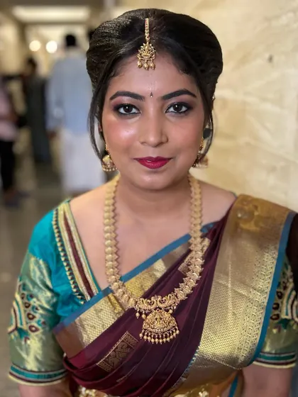 Ready for her friend's wedding. This classic South Indian guest makeup features a sharp wing, bold lips, and a flawless base that stands out beautifully with her silk saree.