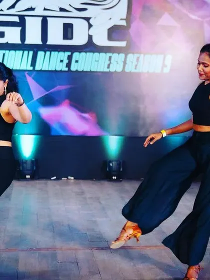 A mid-performance shot capturing the interaction and connection between dancers during our GIDC Mambo piece.