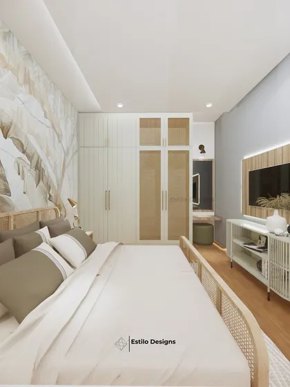 This bedroom design is inspired by tropical tranquility, using a cool grey and beige color scheme. I incorporated a large leaf-patterned wallpaper and cane furniture to bring a natural, calming element into the room.