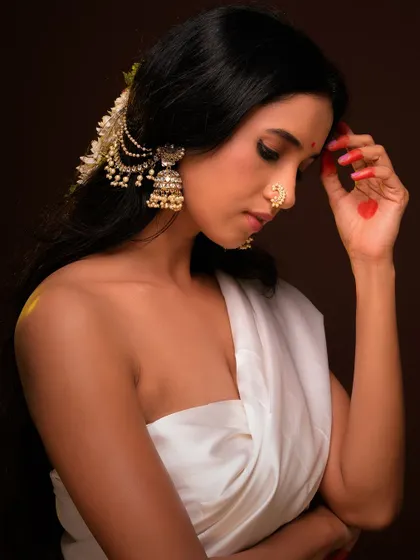 A serene and beautiful ethnic portrait. The model's expression is peaceful, and the traditional styling is highlighted by warm, soft light.