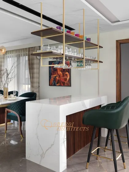 A closer view of the custom bar, highlighting the elegant marble countertop and comfortable leather-finished bar stools.