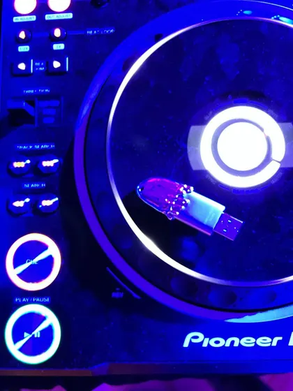 The custom USB drive in its natural habitat, plugged into a Pioneer DJ deck. It’s a small detail, but having custom gear that reflects my brand is important, whether I'm in the studio or playing a gig.