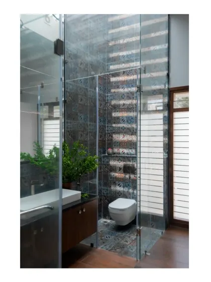 The en-suite bathroom features a skylight over the shower area, bringing natural light into the space and highlighting the patterned tiles.