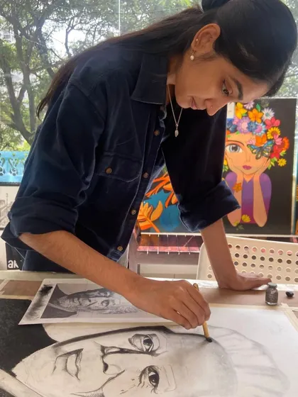 Here, a student is deeply focused on her charcoal portrait. Our courses provide the space and guidance for students to tackle complex projects and mediums they may not try on their own.