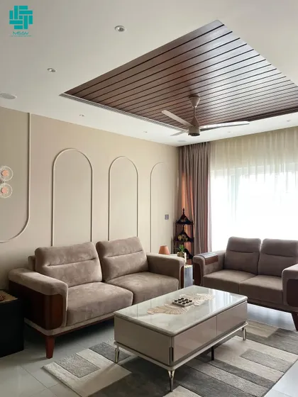This living room is a perfect mix of modern style and cozy comfort. The velvet-finish sofas, wooden slatted ceiling, and arched wall details create a space that is both beautiful and peaceful.
