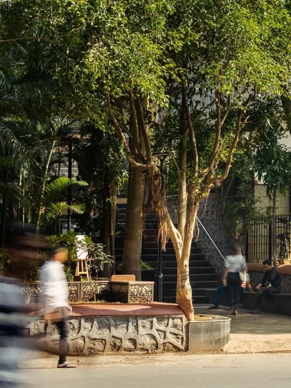 The plaza's edge along the street, where a continuous bench invites passersby to rest. This design blurs the line between the park and the sidewalk, making the space more integrated and approachable.