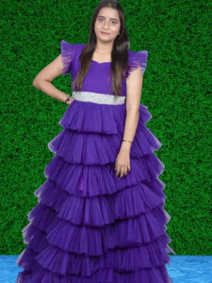 A bold statement in purple. This tiered ruffle gown features a sparkling silver belt that cinches the waist, creating a flattering A-line silhouette.