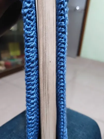 A side view of the crochet book cover, showing how neatly it fits around the book's spine and pages.