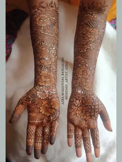 A beautiful and dense floral mehendi design covering the full arms, ideal for a traditional bridal look.