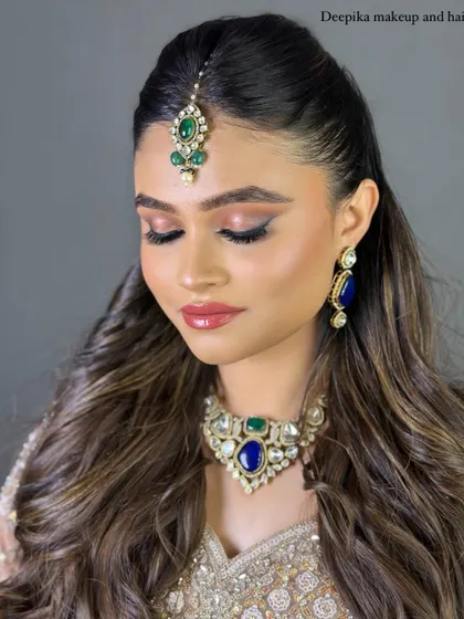 A close-up of the bride with her eyes closed, showing the beautiful pink and gold eyeshadow. This look is perfect for a North Indian wedding ceremony.