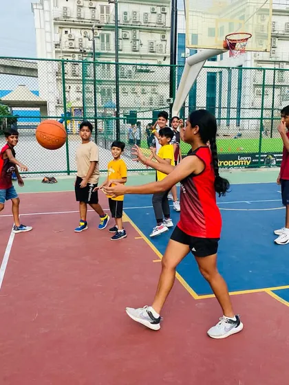 A player practices a bounce pass, a key skill for feeding the post or breaking a press.