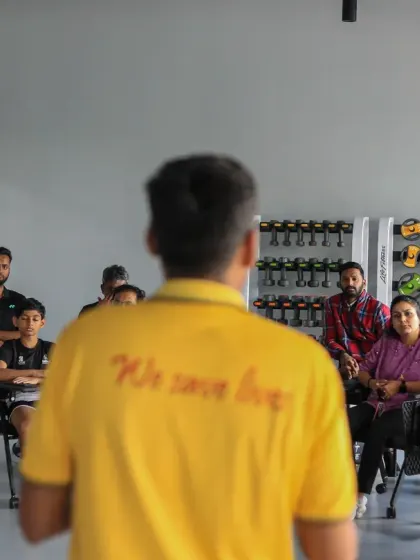 An over-the-shoulder view of our CPR workshop, showing participants listening intently to the instructor.