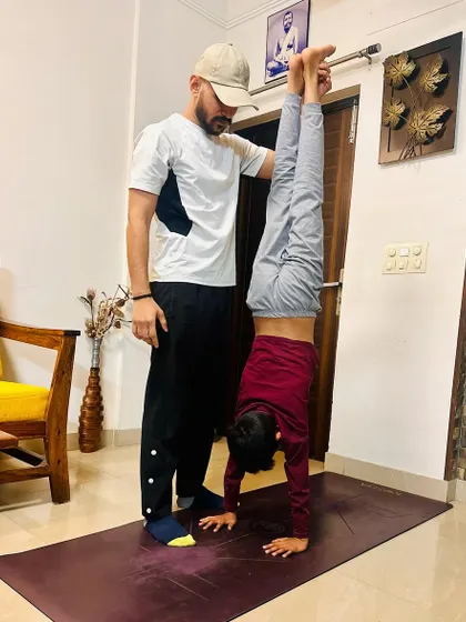 Handstands are a journey of strength and balance. I provide the necessary support to help clients build the confidence and physical stability to hold the pose.