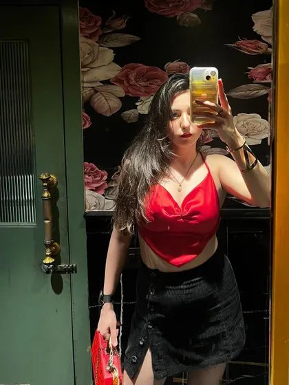 A mirror selfie from a night out, showing off the red and black outfit combo.