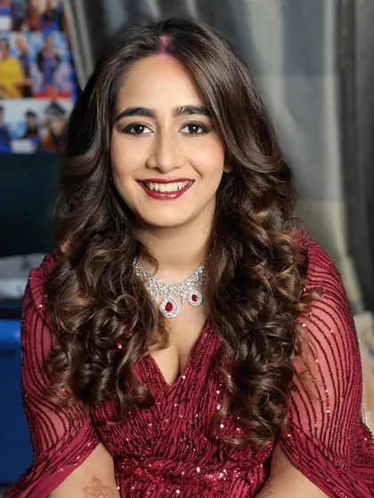A full glam look for this bride's reception. We did voluminous curls and a dramatic eye makeup with a deep red lip, perfect for an evening of celebration.