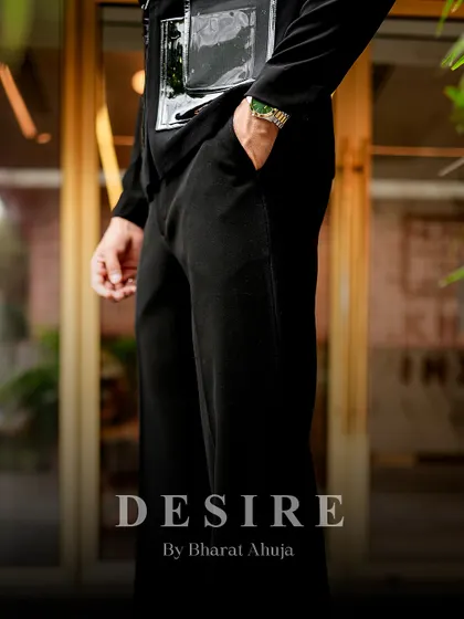 A detail shot of the black utility shirt, focusing on the texture of the fabric and the sleek, modern hardware.