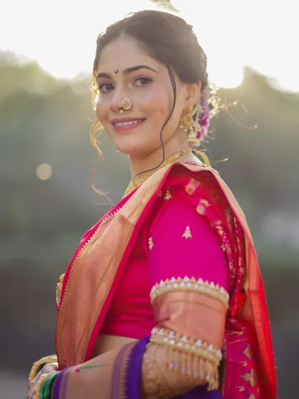 A beautiful, sun-kissed portrait. The natural light enhances the soft glam makeup, highlighting the bride's features and her joyful expression.