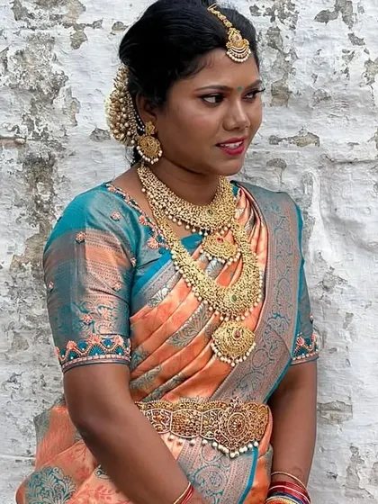 A beautiful client styled in a complete antique gold temple jewellery set, including a statement choker, long haram, and matching vaddanam.