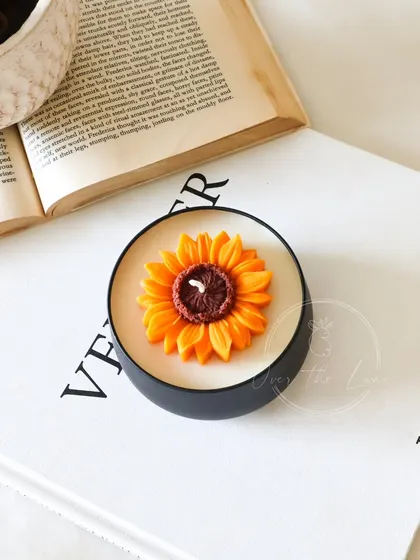 Another shot of a single Sunflower tin jar candle. It's a simple, beautiful piece that brings a touch of nature indoors.