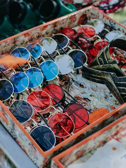 A box full of funky, colorful sunglasses, ready for guests to grab and get into the festival spirit at our "Diving with Rhe" party.
