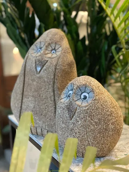 Our quirky 'Goobey' statues, captured here among plants, make for a fun and lovable gift for the special 'goobey' in your life.