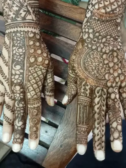 A beautiful Karwa Chauth mehendi with full hands, combining different geometric and traditional patterns.