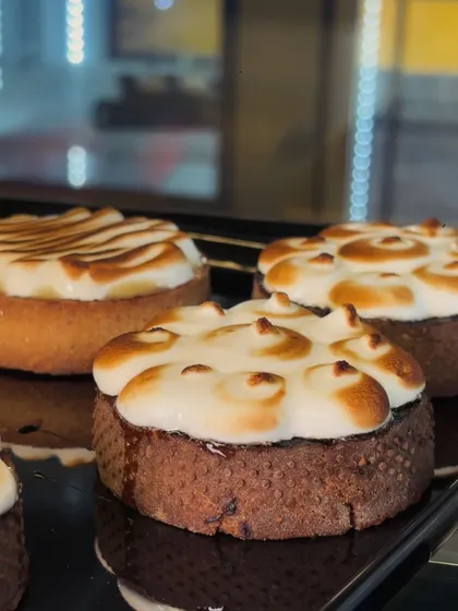 Small round desserts with browned cream tops sit in our display, with their baked bases visible underneath.