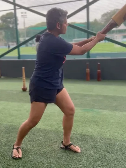 Practicing a rotational movement with a traditional Indian club. This exercise directly mimics the coiling and uncoiling motion of the golf swing.