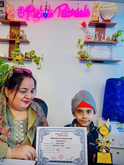 Here is another champion with his well-earned trophy and certificate from the National Level Championship. His dedication and hard work have paid off.