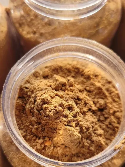 A close-up of the Chocolate Ubtan powder, showing its fine, herbal texture.