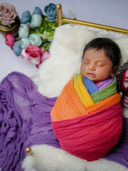 A peaceful rainbow. I love using colorful wraps to add a touch of brightness and joy to my classic swaddled poses.