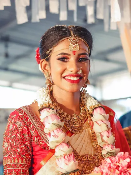 A close-up that captures the emotion and beauty of the moment. The makeup is fresh, and the bride's happiness shines through.