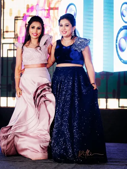 Another shot of the bride and her sister on the sangeet stage, showcasing their coordinated yet individual styles.