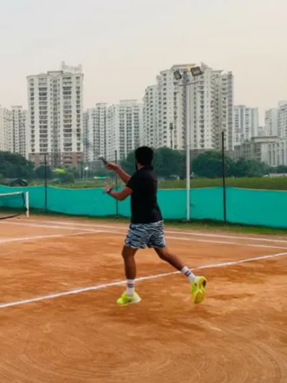 An action shot of a junior player practicing his backhand during a training session. Our programs are designed to develop all aspects of a player's game, from groundstrokes to serves.
