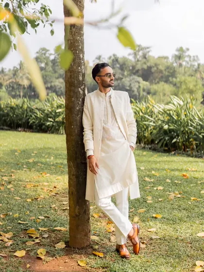 A suave portrait of the groom in his elegant ivory kurta set, showing that comfort and style can go hand-in-hand for a Goa wedding.