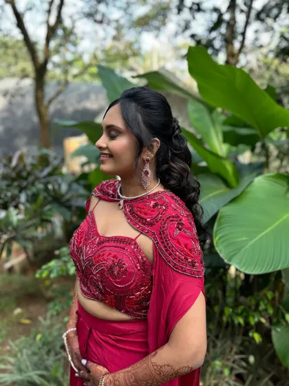 A side view of the half-up, half-down hairstyle, showing how it frames the face beautifully. The soft curls add a touch of romance.