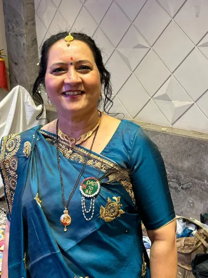 The mother of the bride, looking so happy and proud. Her traditional bun hairstyle is perfect for the occasion.